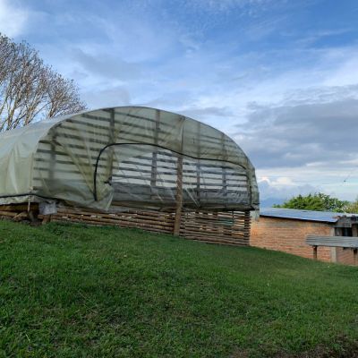 A covered drying room made from split bamboo and tarpaulin is used to dry coffee during the harvest season. Vereda Belén, Inzá, Cauca Department, Colombia.