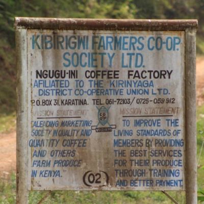 The sign leading into the Ngugu-ini Coffee Factory in Kirinyaga displays the mission statement for all coffee cooperative members. Karatina, Kenya.