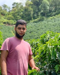 Carlos Umberto poses for a photo at his green coffee farm in San Luis Planes, Santa Barbara municipality, Honduras.