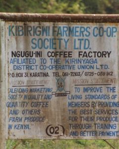The sign leading into the Ngugu-ini Coffee Factory in Kirinyaga displays the mission statement for all coffee cooperative members. Karatina, Kenya.