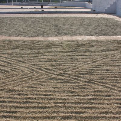 Parchment-covered green coffee drying on patios in Karnataka region of India.