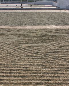 Parchment-covered green coffee drying on patios in Karnataka region of India.